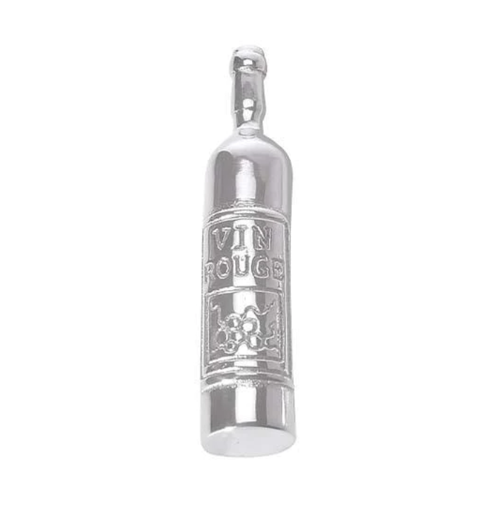 A silver-colored wine bottle-shaped napkin weight with text and decorative elements on it.