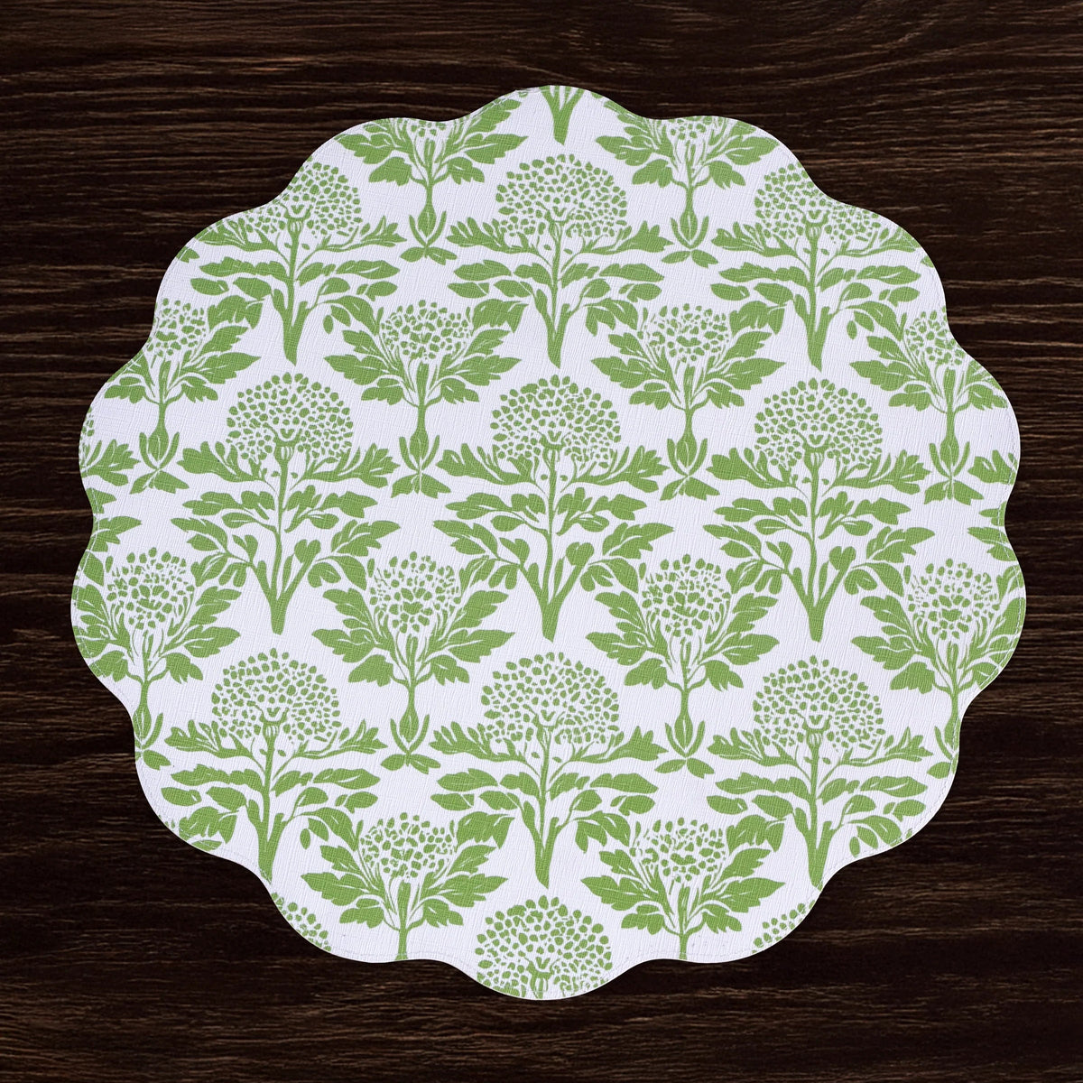 Placemat with green floral pattern on a wooden surface