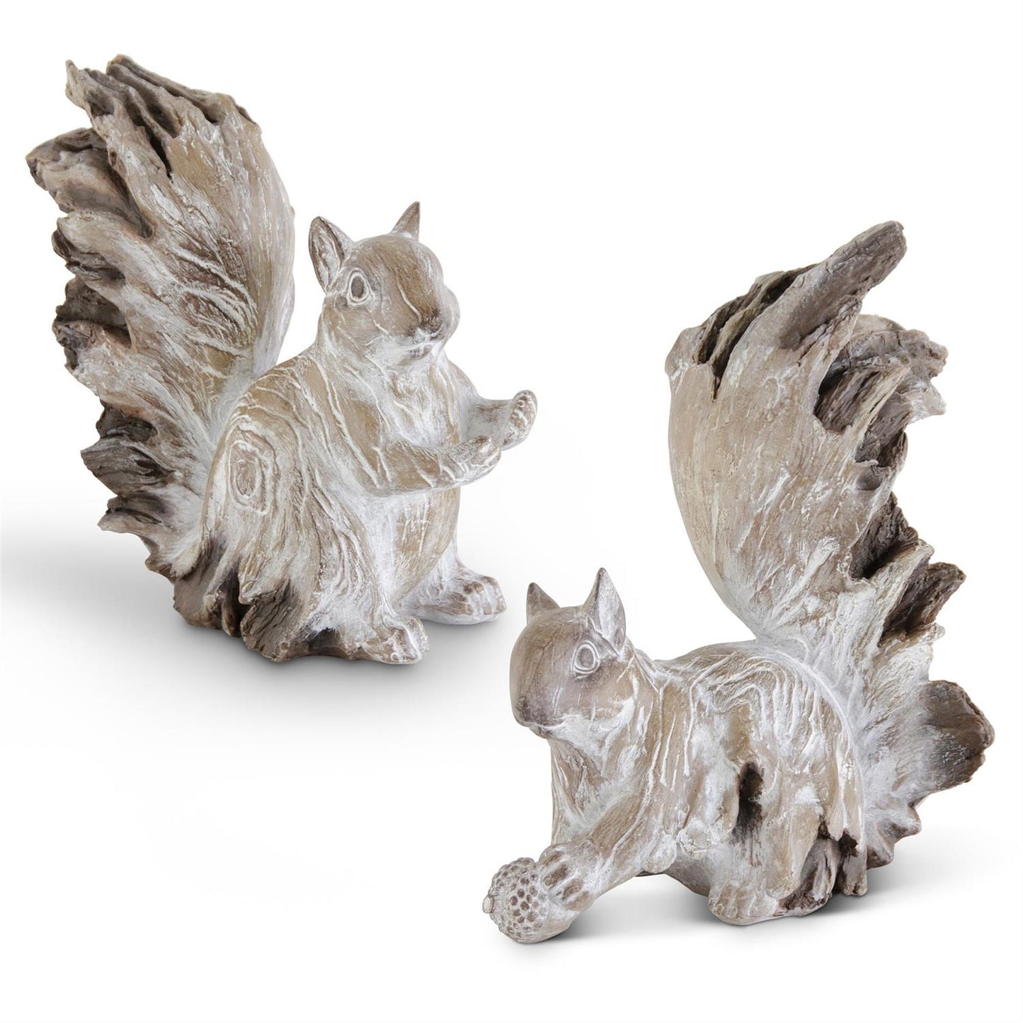 Two squirrel figurines with a weathered finish one is sitting and the other is crouching and holding an acorn