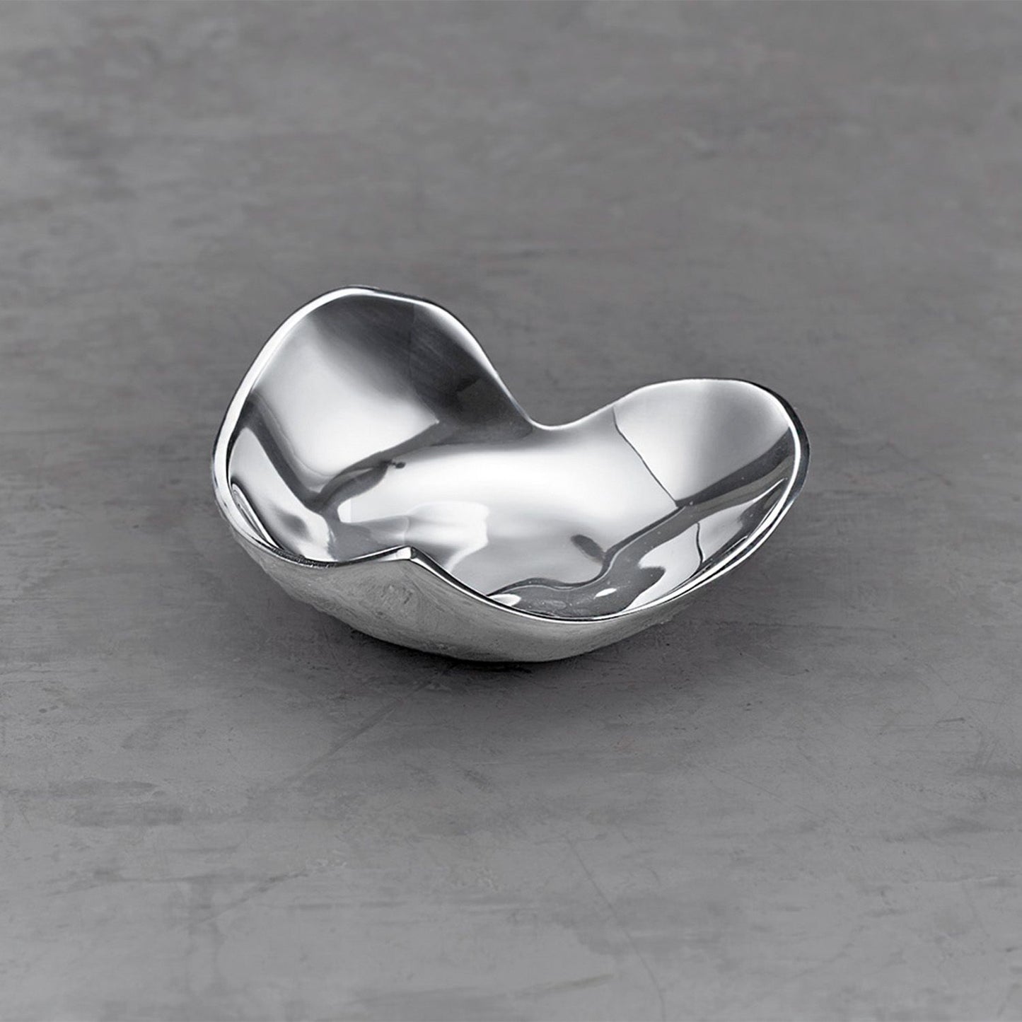 A silver, heart-shaped decorative dish by Beatriz Ball, designed for serving nuts and nibbles or holding small jewelry.