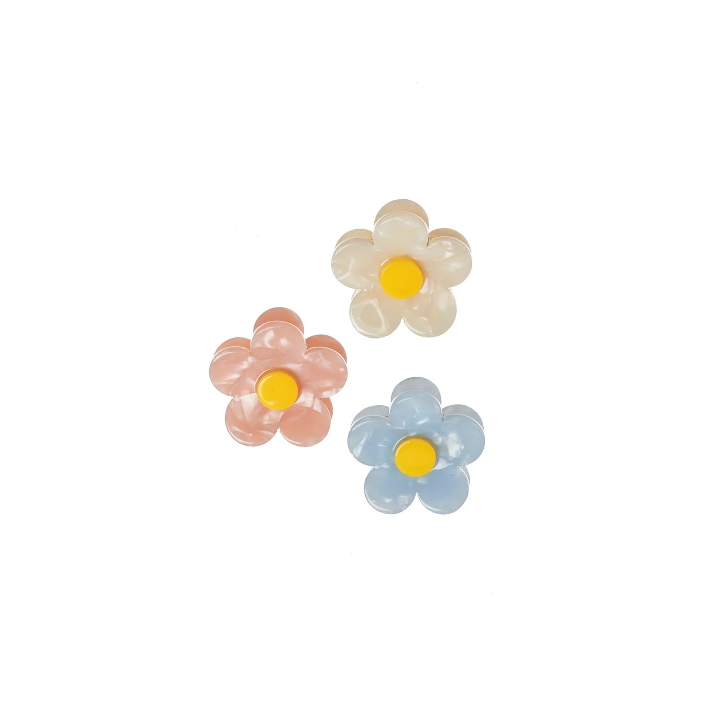 Three flower-shaped hair clips in pink, white, and blue