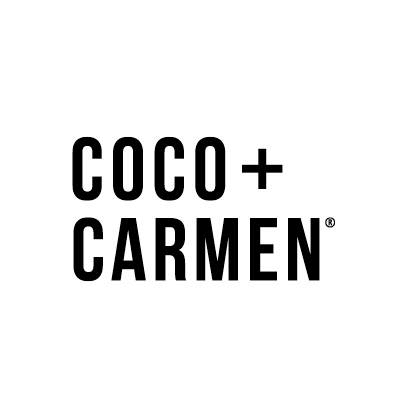 The text 'COCO + CARMEN' appears in a black sans-serif font on a plain white background. Coco + Carmen brand is sold at The Little Exchange Fine Gifts in Oakwood just south of Dayton Ohio