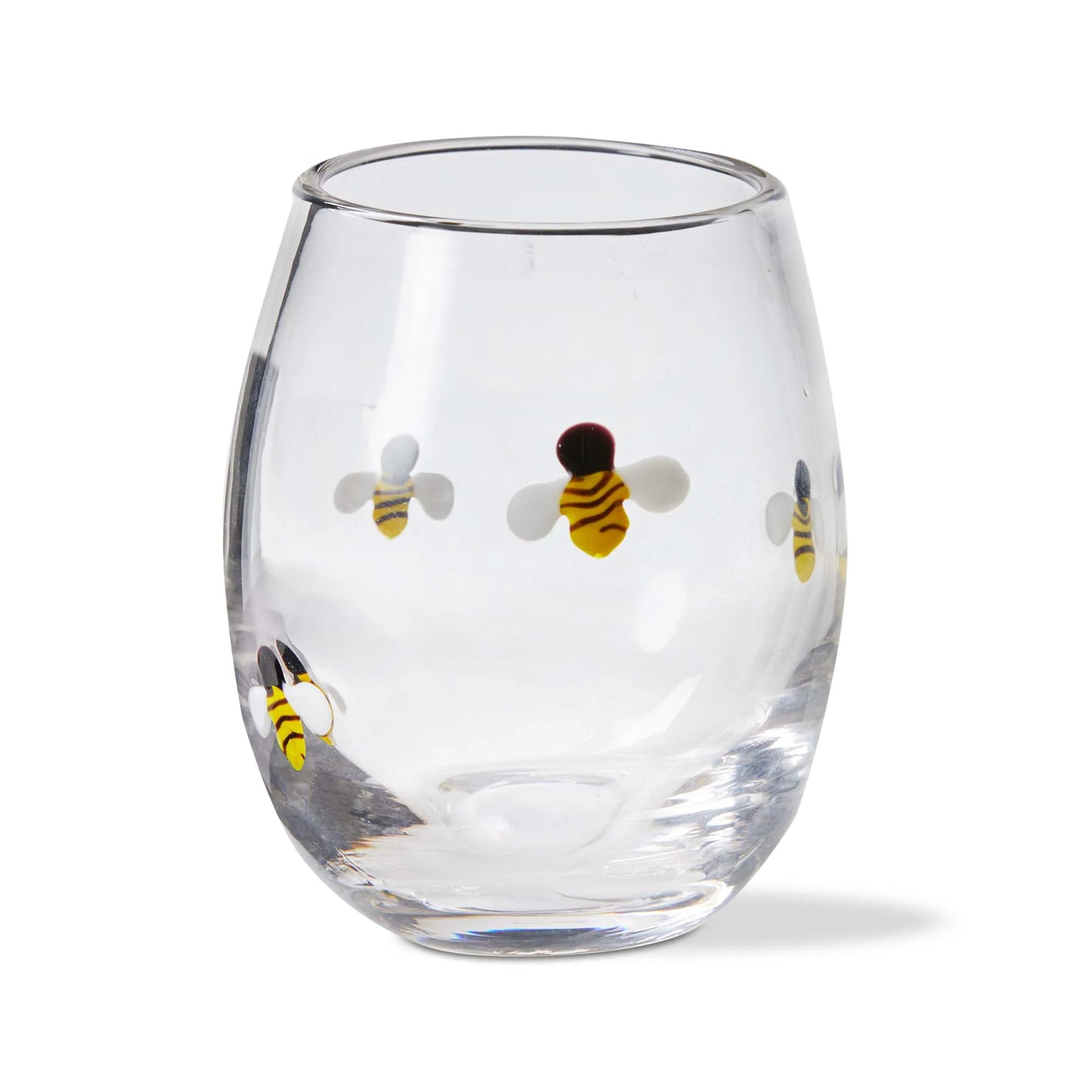 A clear stemless wine glass with a hand-applied glass bead bee icon design.