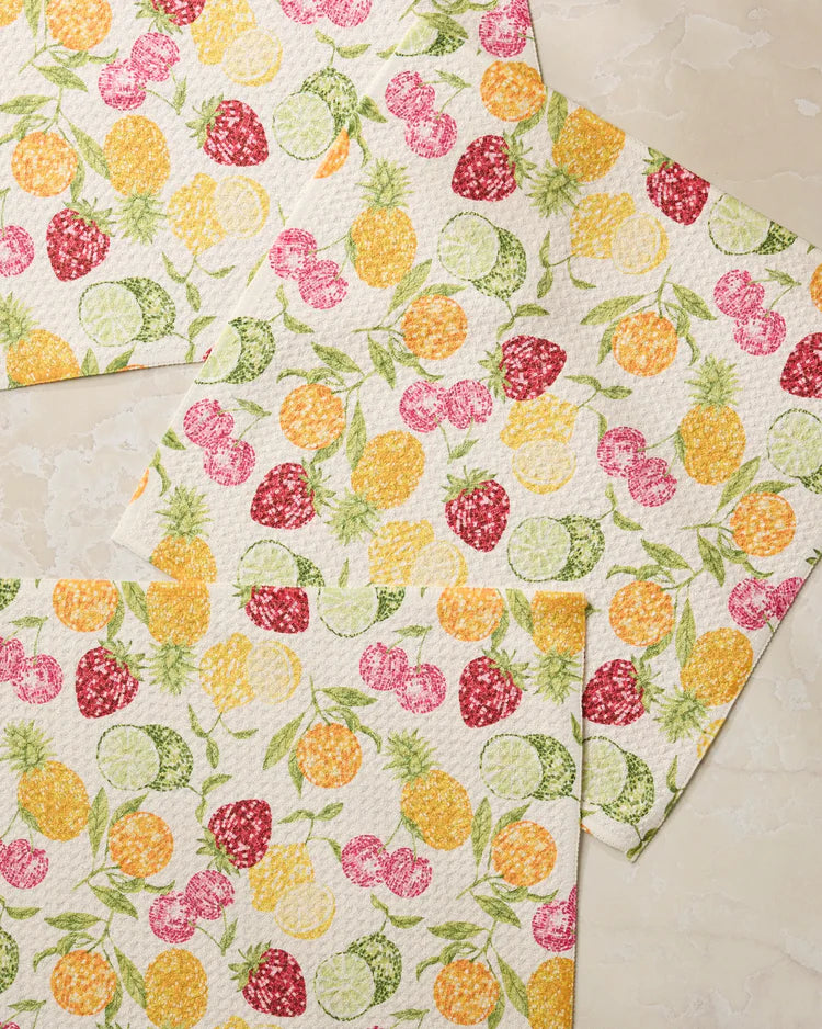 Three Geometry dishrags with a colorful fruit disco pattern on a neutral background
