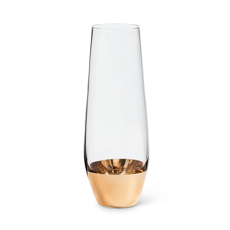 A stemless flute with a wide gold base and clear upper part.