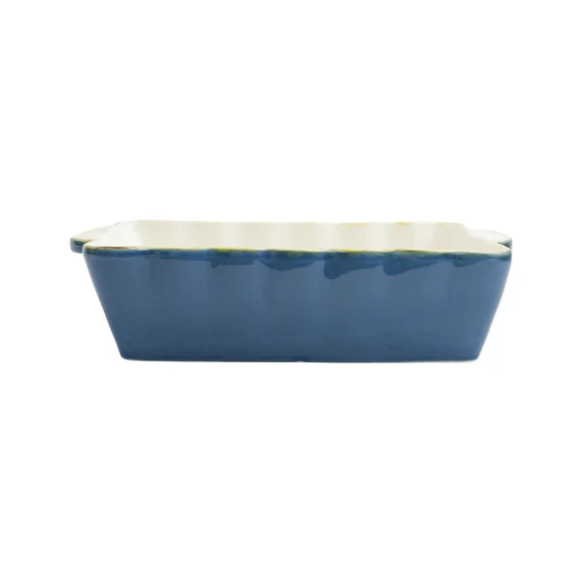 Blue rectangular ceramic baking dish with a scalloped edge