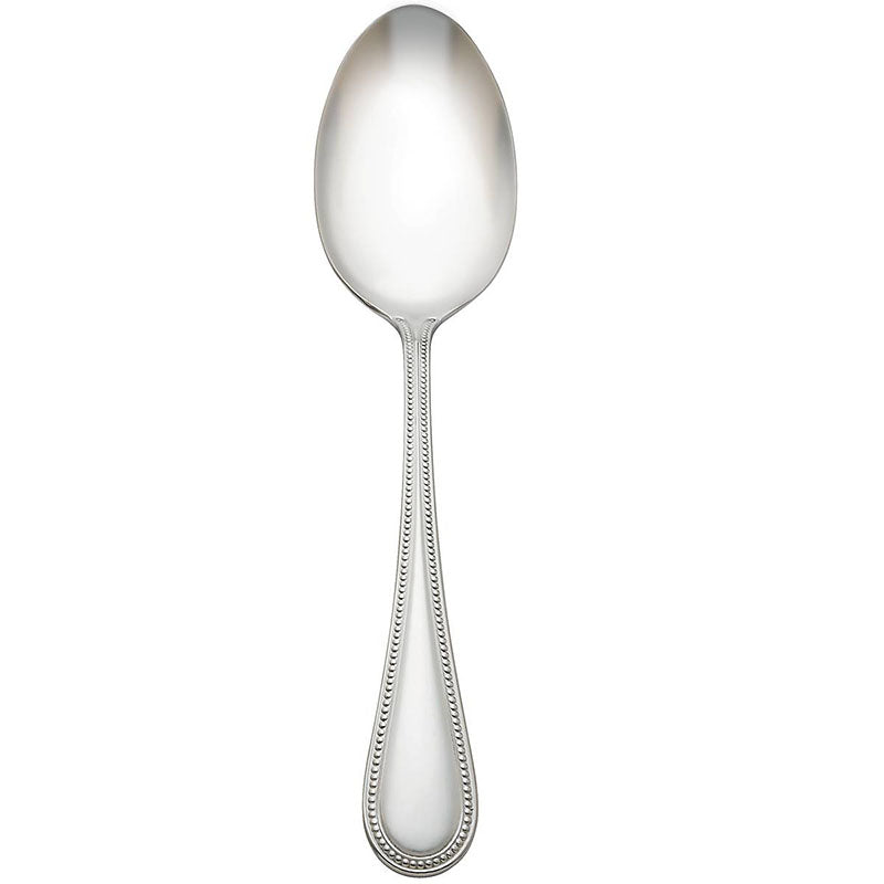 A silver buffet spoon with a classic beaded design on the handle.