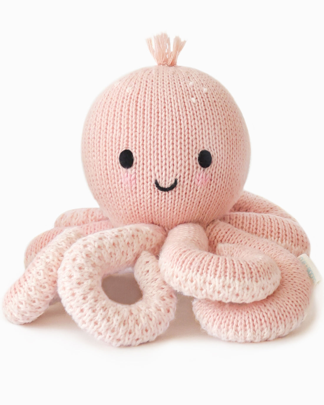 Knitted pink octopus toy with a smiling face on a white background