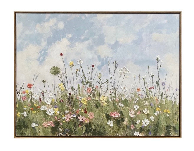 Framed artwork of a field of wildflowers with a blue sky.