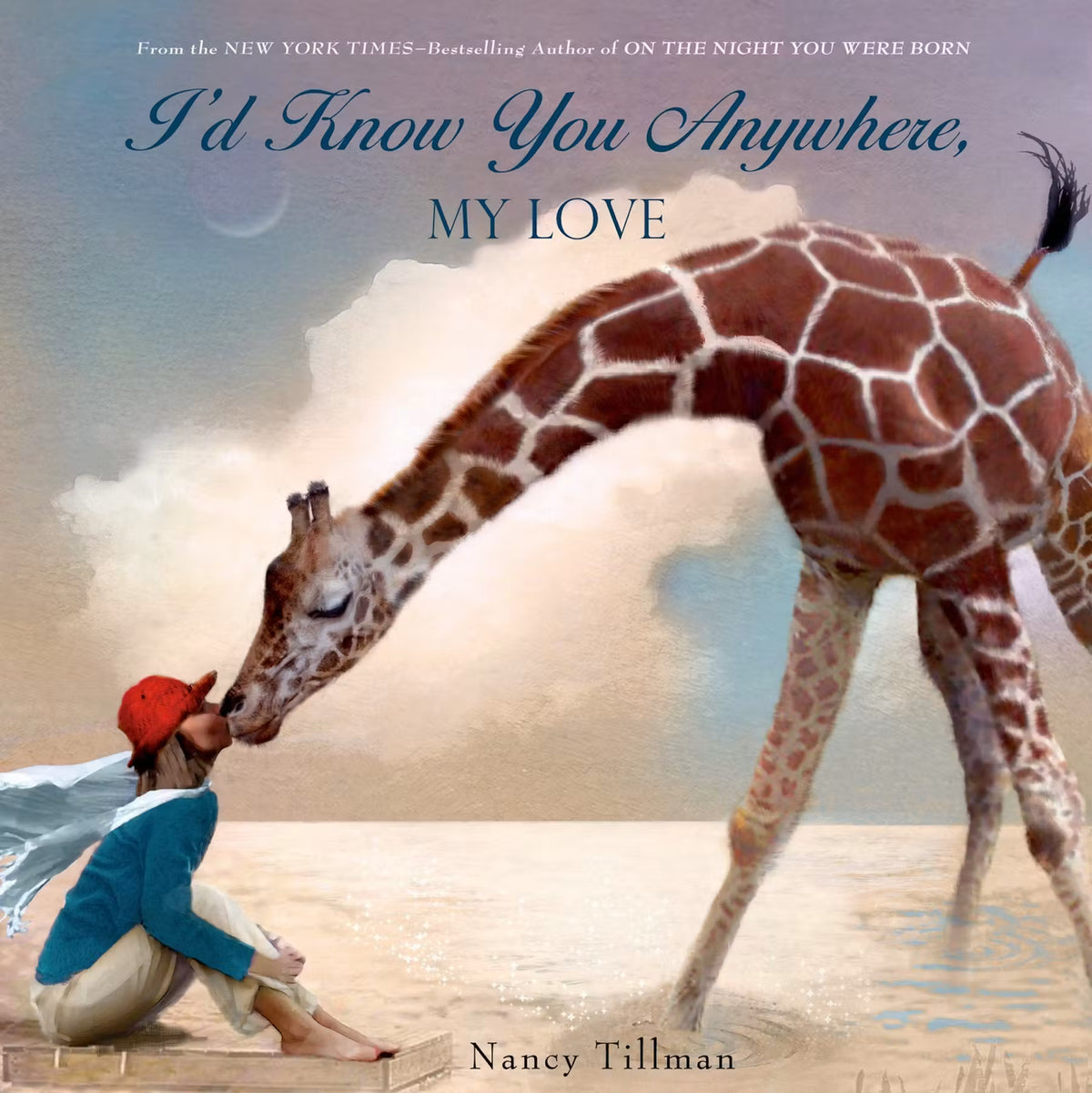 Book cover of 'I'd Know You Anywhere, My Love' by Nancy Tillman featuring a child and giraffe on a beach.