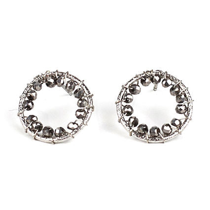 round silver earrings encased in hematite crystals
