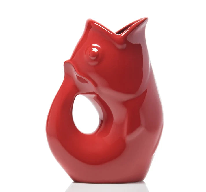 Red ceramic GurglePot pitcher shaped like a fish featuring a gurgling noise