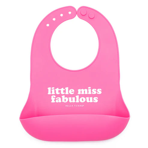 A pink silicone baby bib with the text 'little miss fabulous' printed on the front.