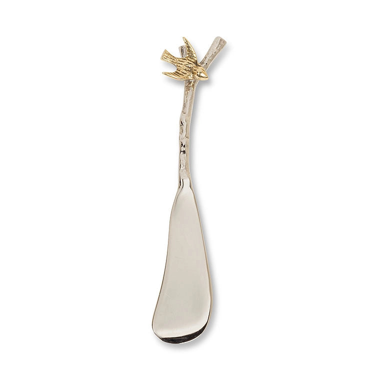 Decorative spreader with a handle with a brass bird on a branch
