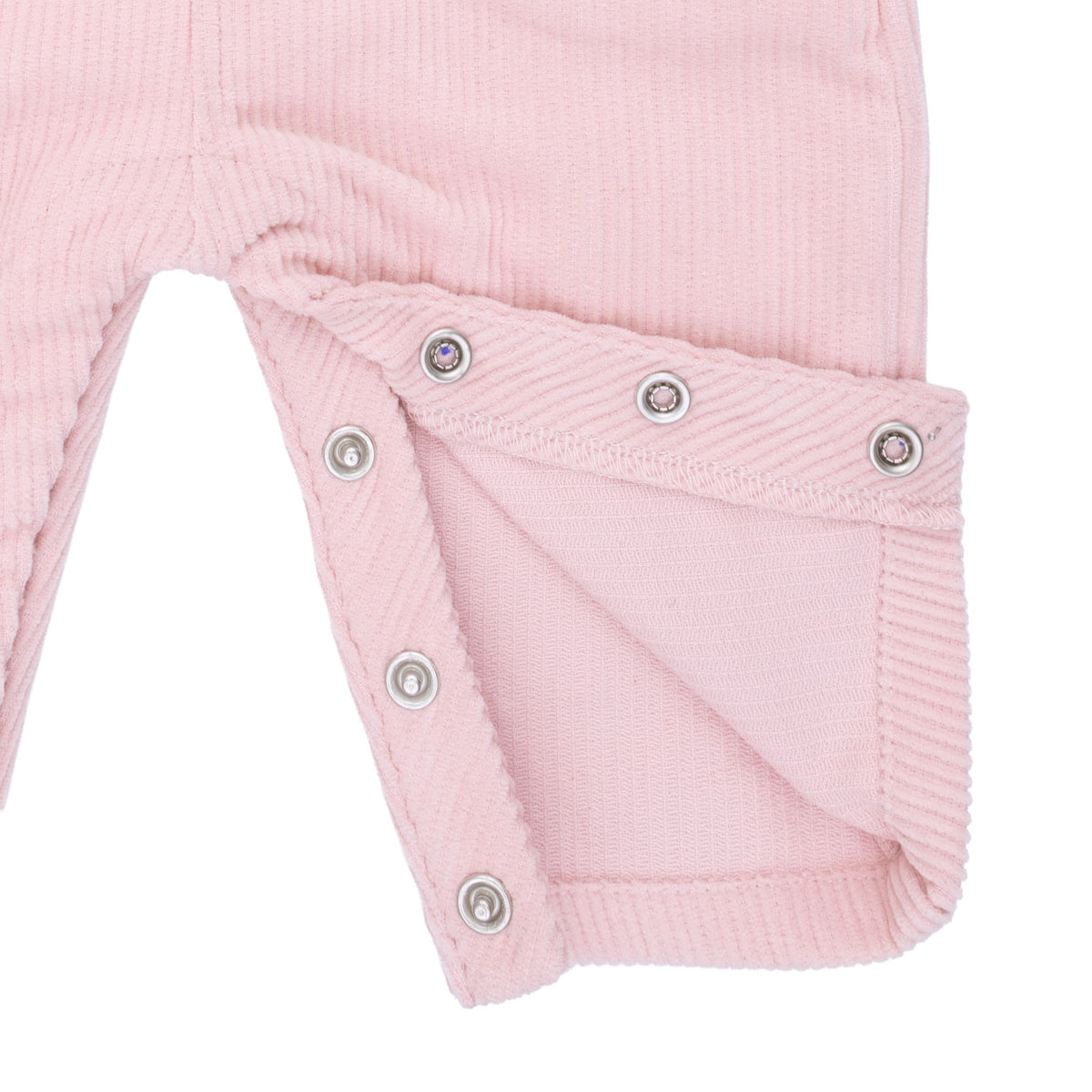 Close-up of a pink corduroy overall leg with snap details on a white background