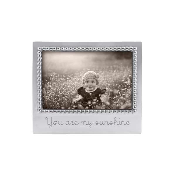 A beaded silver photo frame with the inscription 'You are my sunshine' on the bottom.