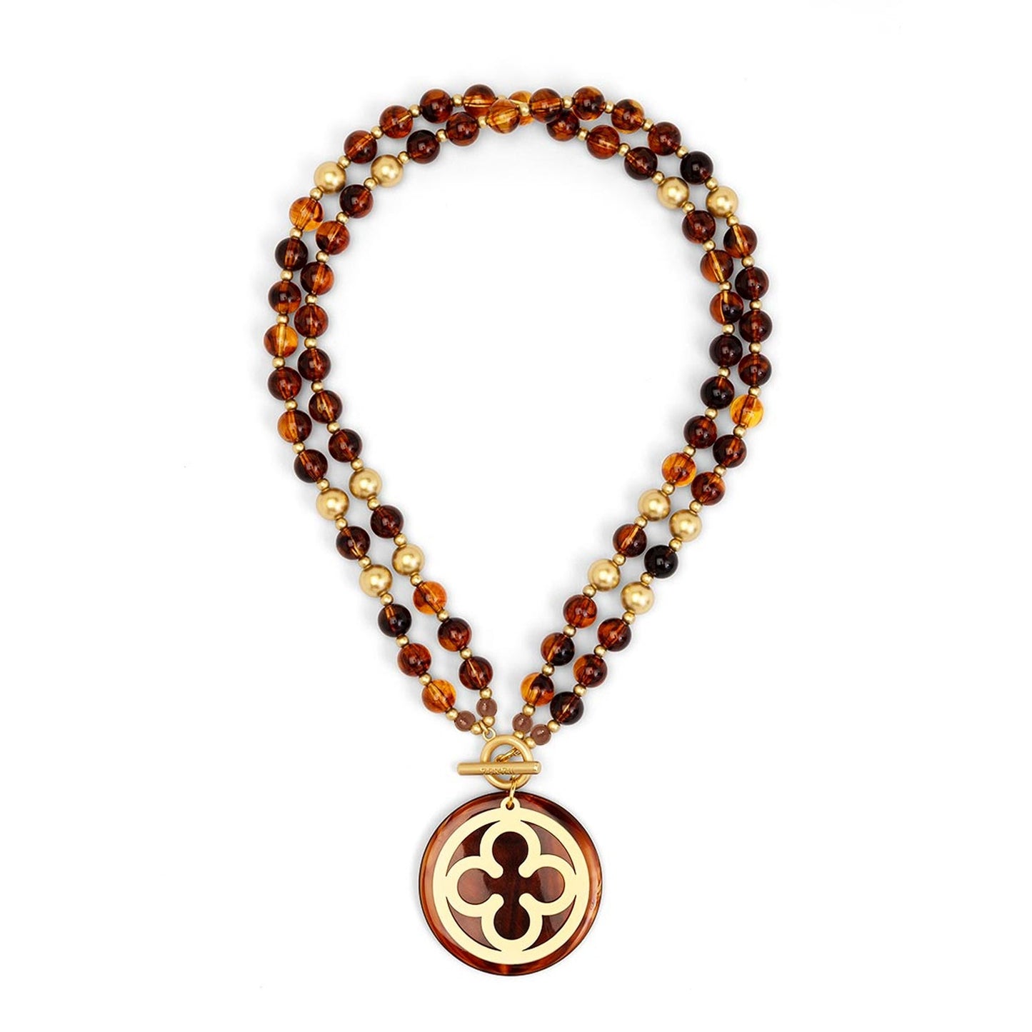 A beaded necklace featuring amber brown, translucent orange, and gold faceted beads, with a gold-tone clasp and a matching round pendant displaying a cutout quatrefoil design.