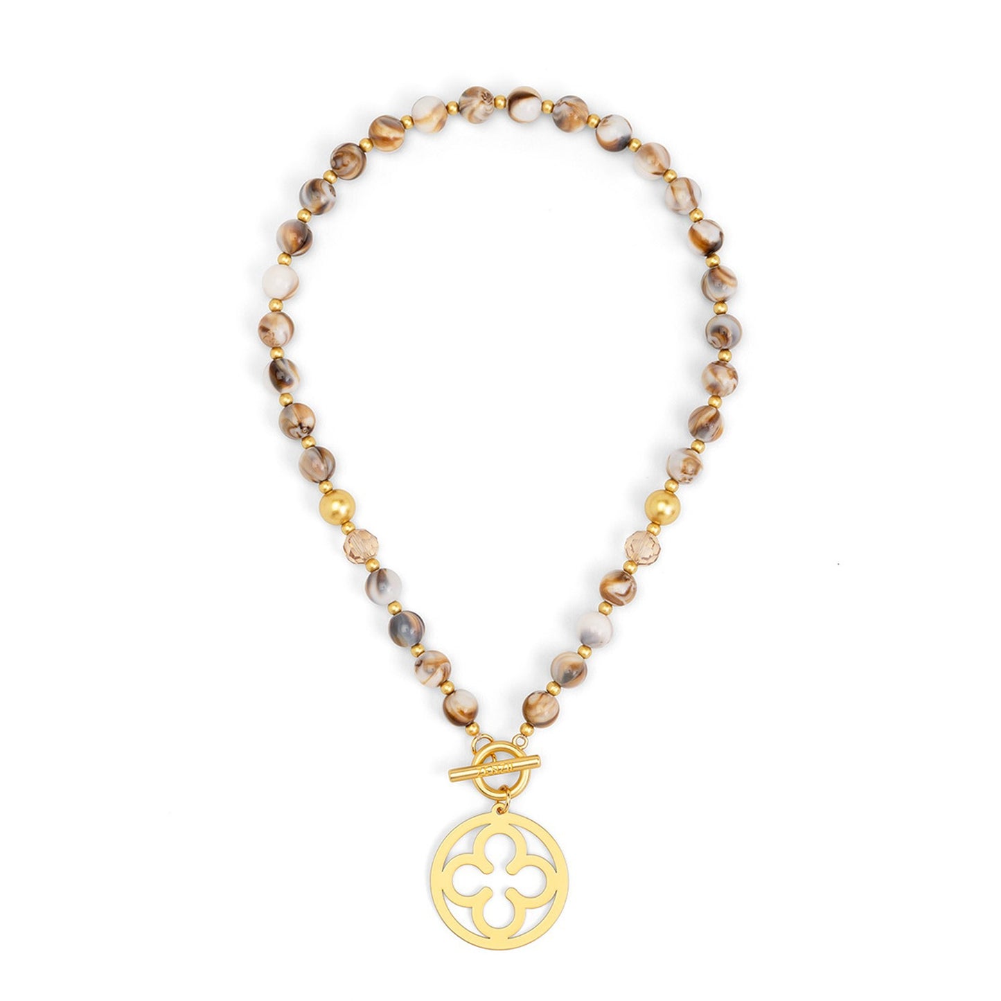 A beaded necklace featuring brown and beige marbled beads with small gold spacer beads, finished with a gold toggle clasp and a circular gold pendant with a quatrefoil cutout design.