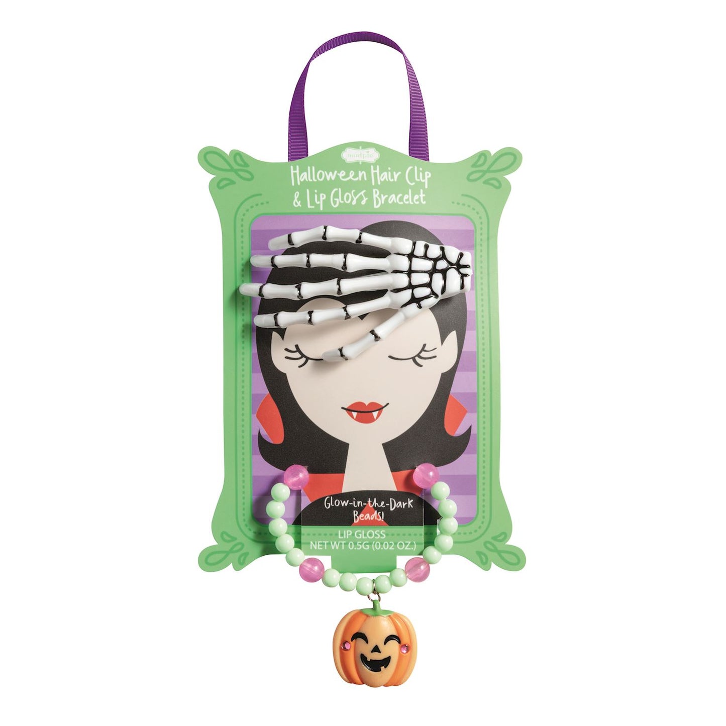 Halloween hair clip and lip gloss bracelet set, displayed on its green illustrated packaging card with a purple hanging ribbon. The set includes a skeleton hand-shaped hair clip and a beaded lip gloss bracelet with a small orange jack-o'-lantern charm.