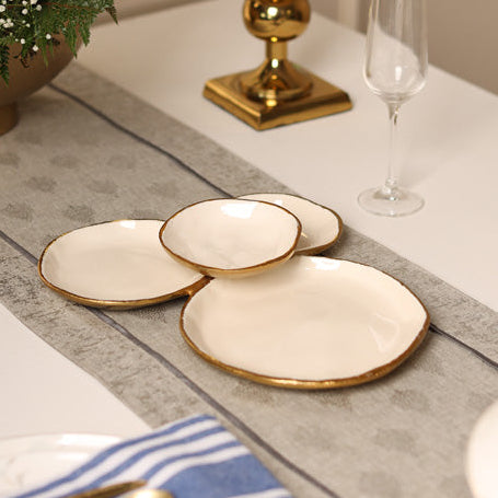 white with gold trim four bowl cluster of different sizes and connected as one serving piece