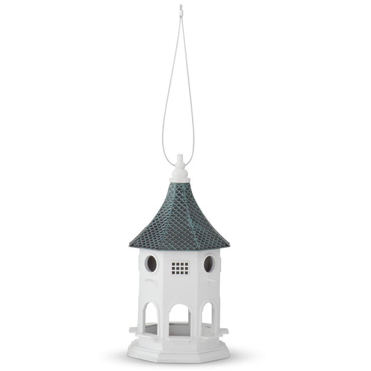 White birdhouse with a blue and black tin roof on a white background