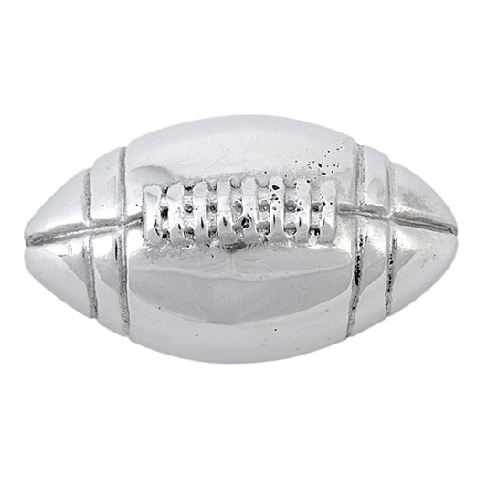 A silver aluminum football-shaped napkin weight with embossed details resembling stitching.