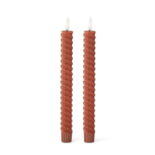 Two twisted LED taper rust-colored candles
