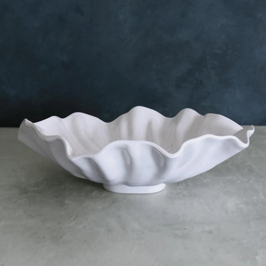 White luxury melamine bowl with wavy edge on a gray surface 