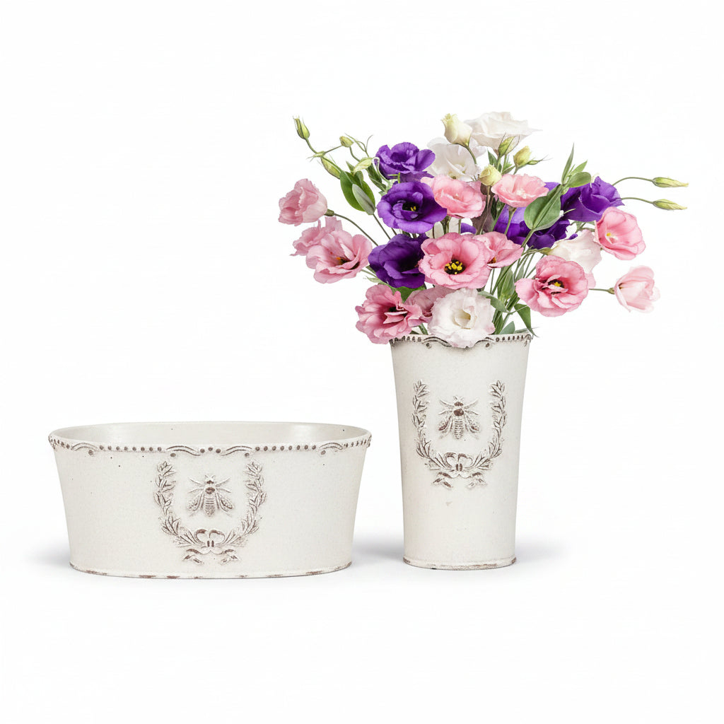 a tall and oval cement planter with a bee in crest emboss design