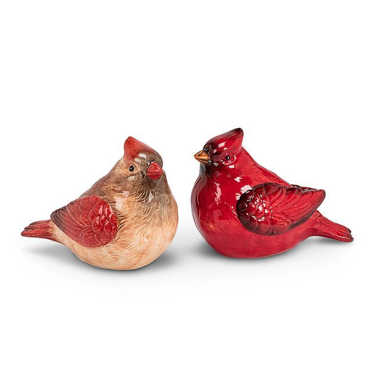 A pair of ceramic salt and pepper shakers painted to resemble ta male and female cardinal.