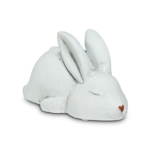 White sleeping rabbit made of cement with a heart nose