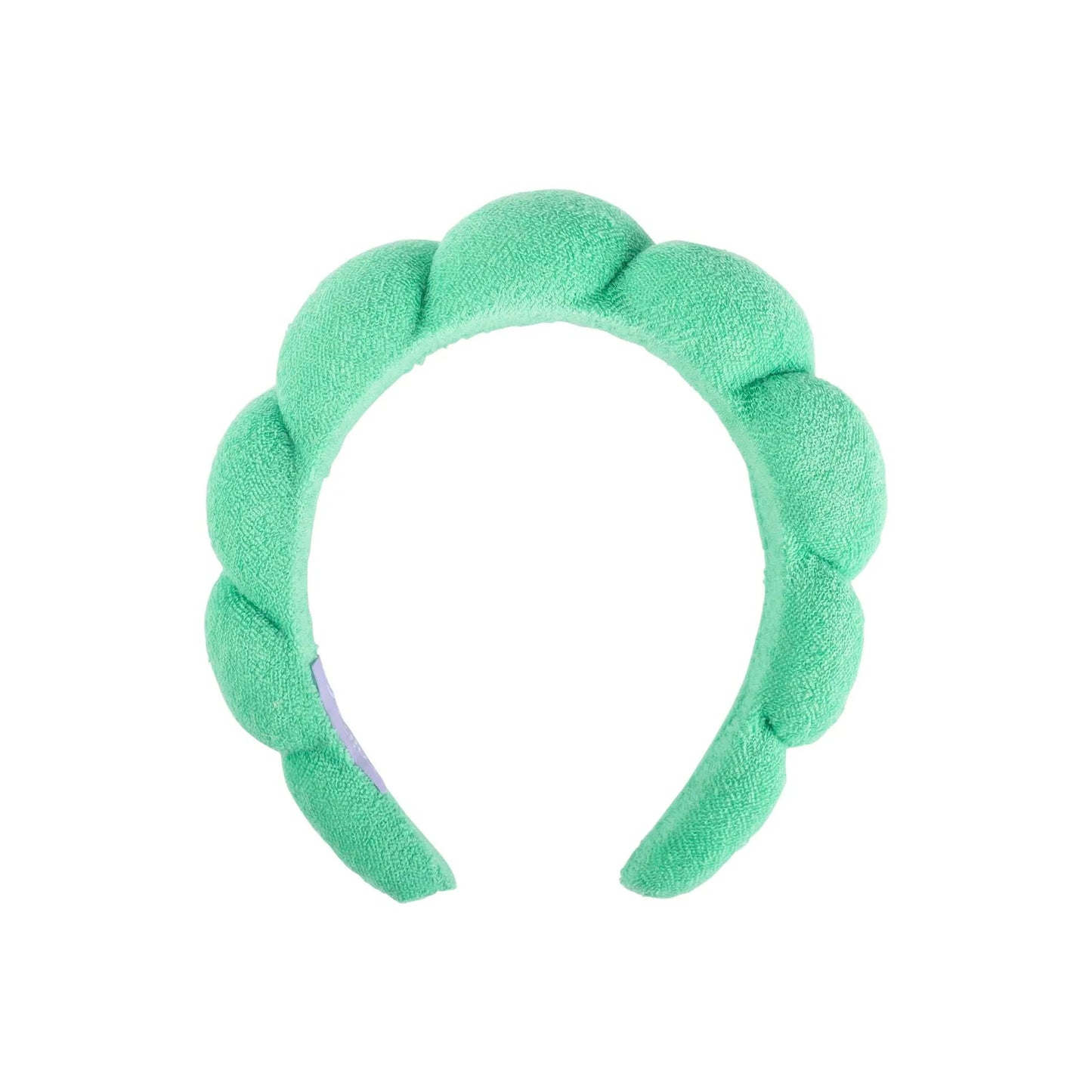 A mint green plush spa headband on a solid white background.