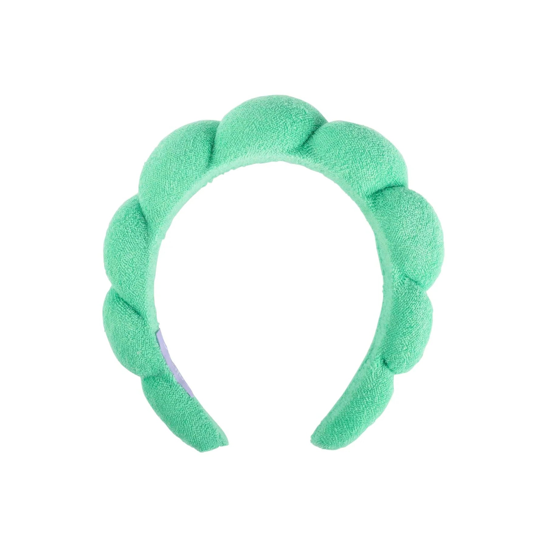 A mint green plush spa headband on a solid white background.