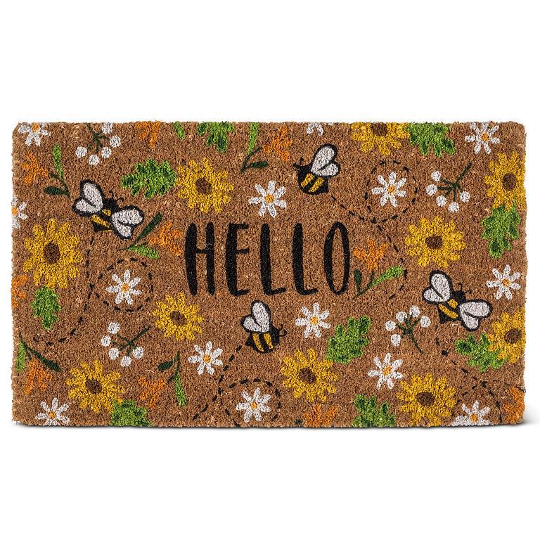 coir doormat featuring daisies and bees and the greeting "welcome" in the middle