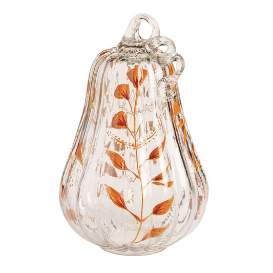 Clear glass pumpkin with orange leaf design on a white background