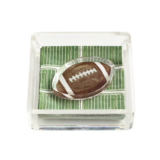 clear acrylic napkin holder with napkins that look like a football field and a napkin weight in the shape of a brown football