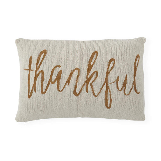 Beige knit pillow with yellow 'thankful' text on a white background