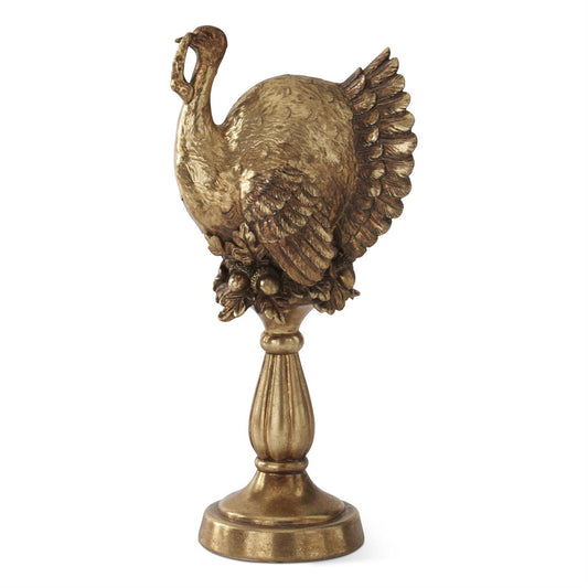 antique gold statue of a turkey on a column pedestal.