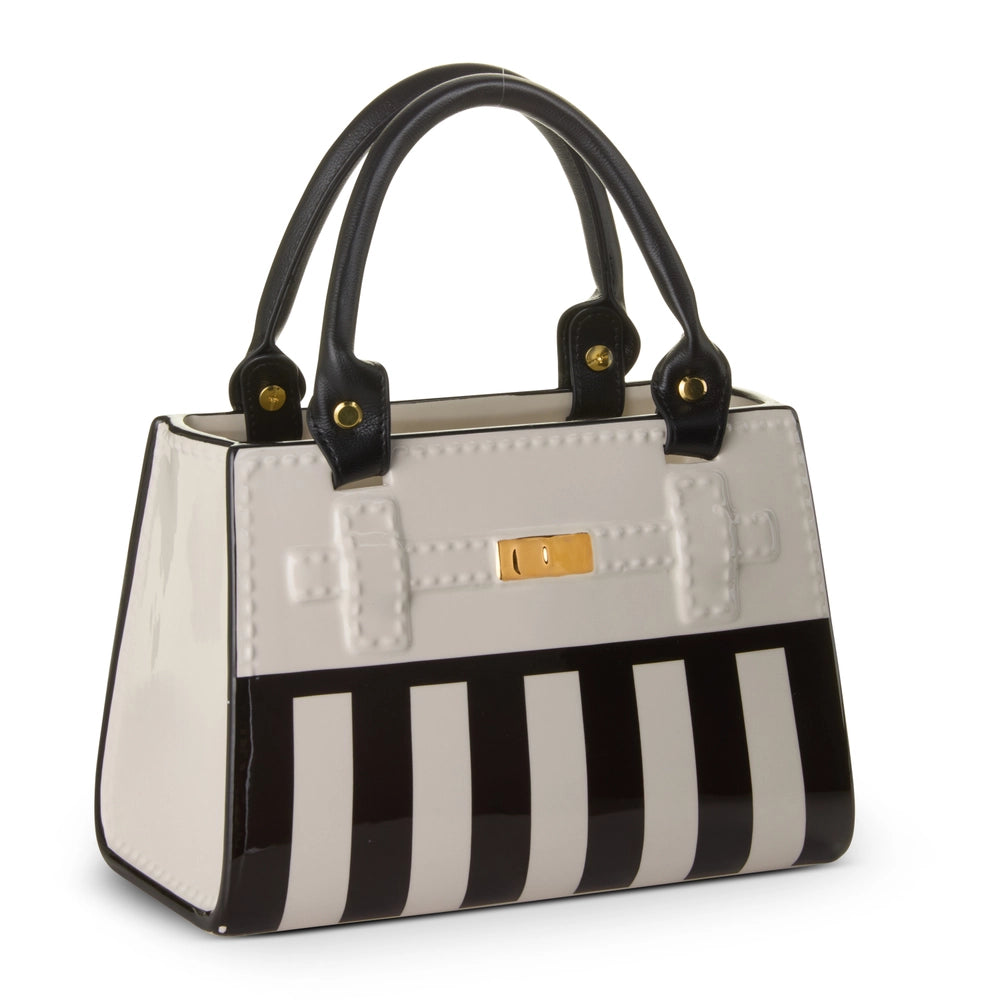 Ceramic handbag vase with black and white striped design on a white background