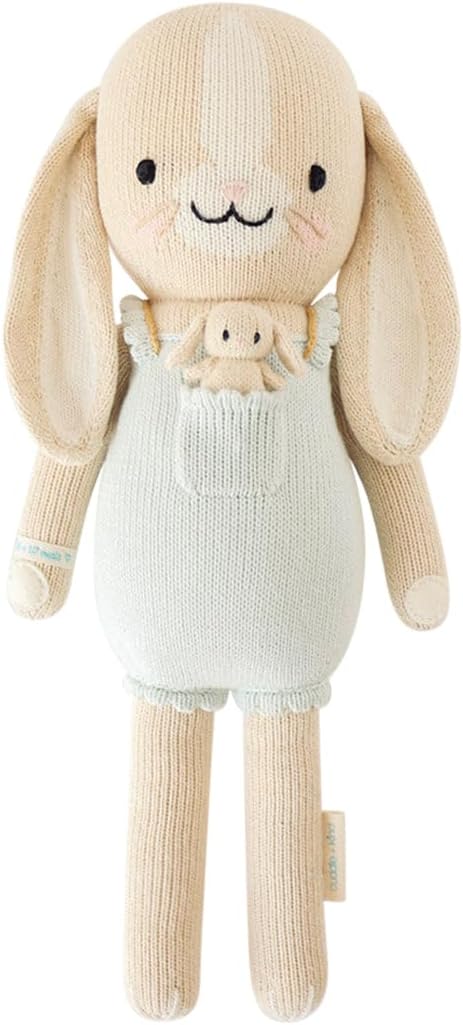 hand knit toy rabbit wearing a mint green outfit with a baby bunny in the pocket
