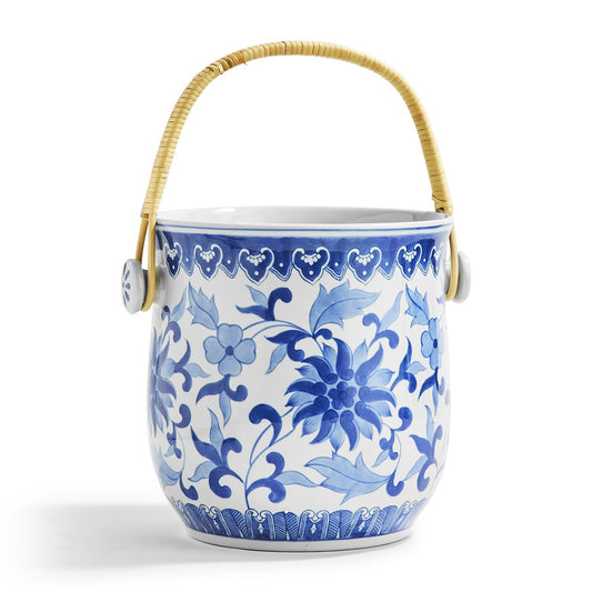 Ceramic ice bucket with blue floral patterns and a bamboo handle 