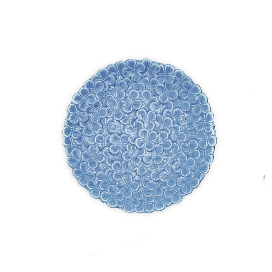 Round blue placemat with floral pattern on a white background