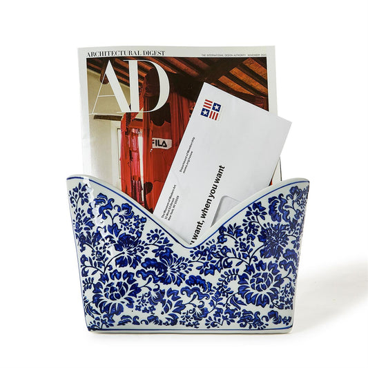 Blue and white floral-patterned letter holder with Architectural Digest magazine and envelope 