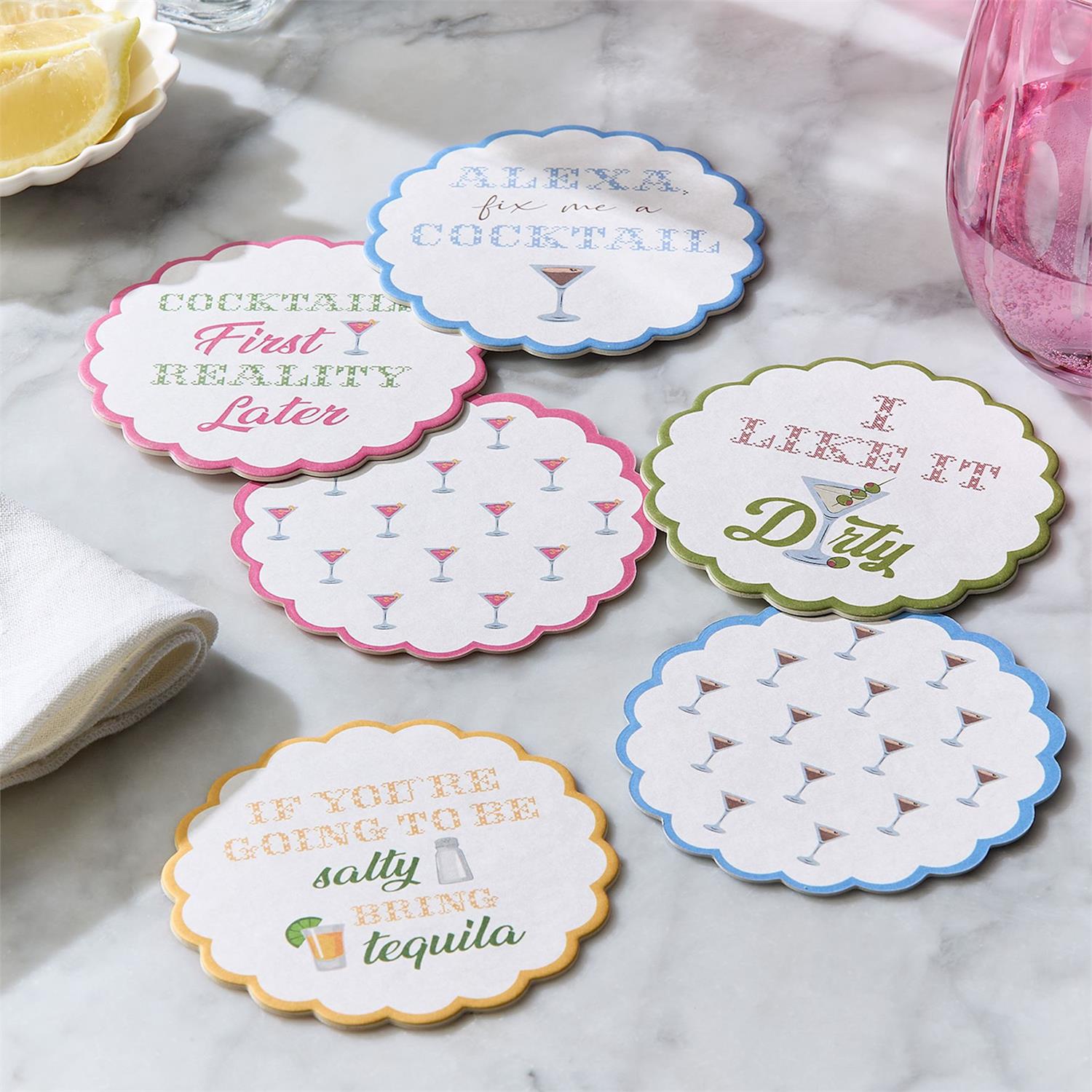 Set of six humorous cocktail-themed coasters on a marble surface.