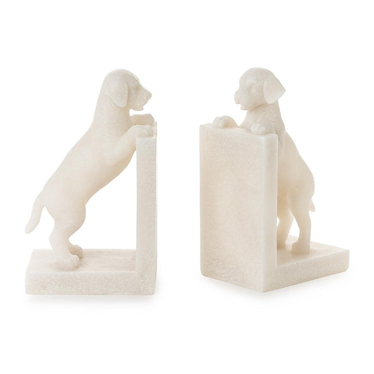 Two white marble bookends shaped like dogs on a white background