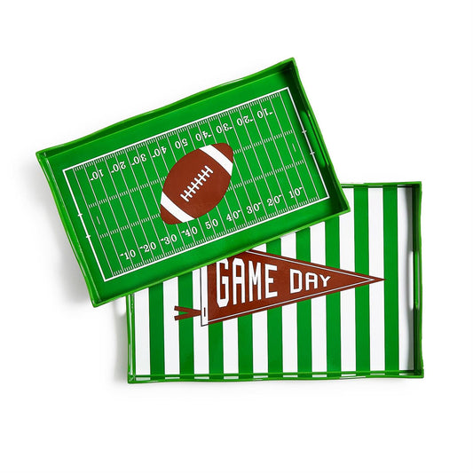 Two trays one with a green and white stripe design and 'Game Day' banner, the other with a football field design and a brown football in the middle
