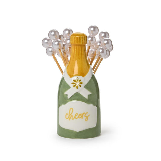 Cocktail pick holder in the shape of a champagne bottle with 'cheers' text and picks with pearl tops