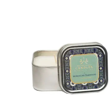Moroccan Teakwood lotion Candle in a decorative tin with a label on a white background
