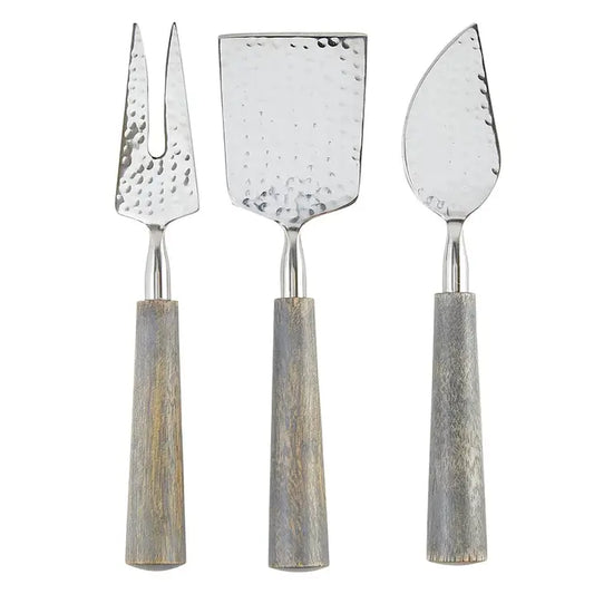 More Cheese Please Set of three metal cheese tools with wooden handles on a white background