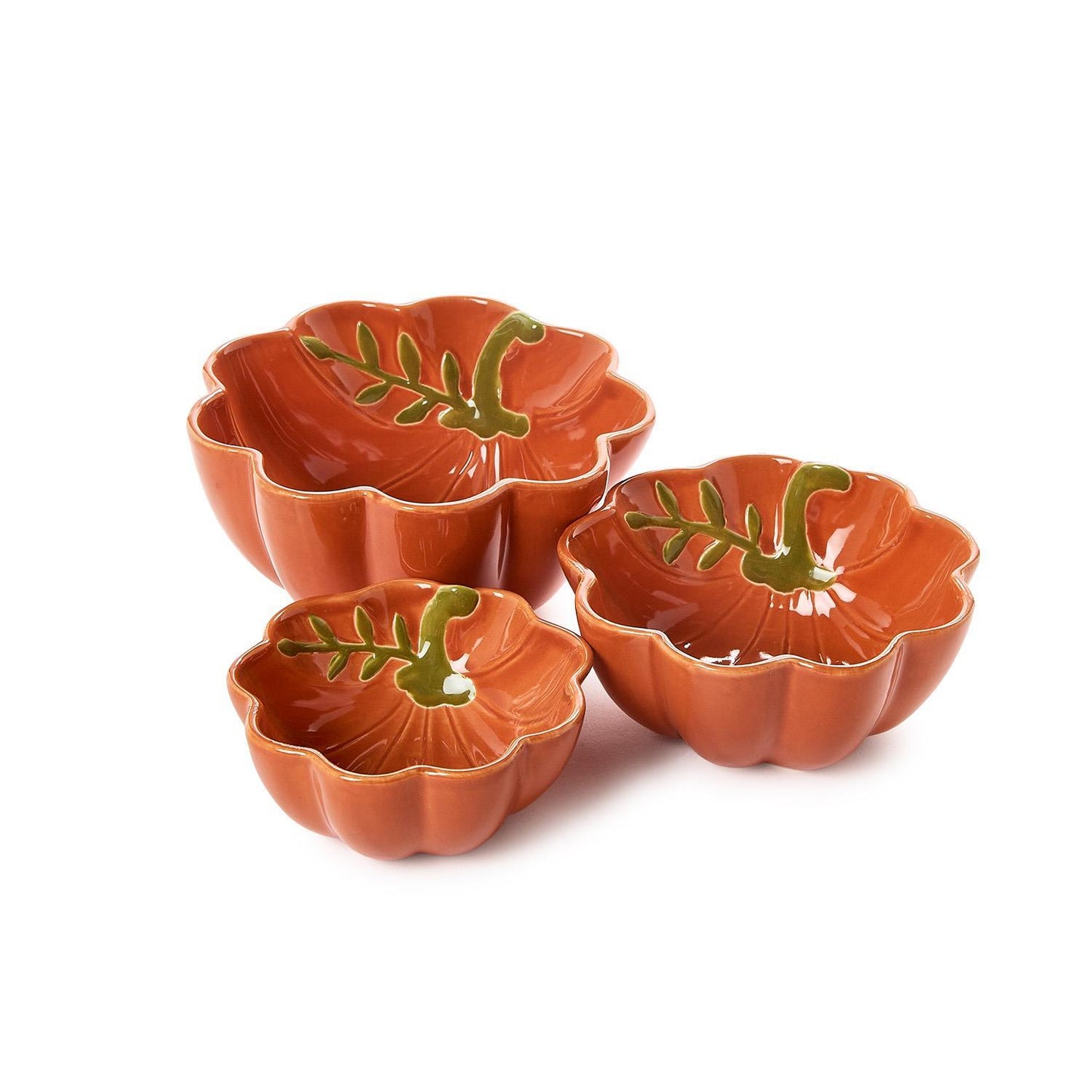 Three pumpkin ceramic bowls in a warm terracotta orange color, decorated with a green leaf design inside, arranged on a white background.